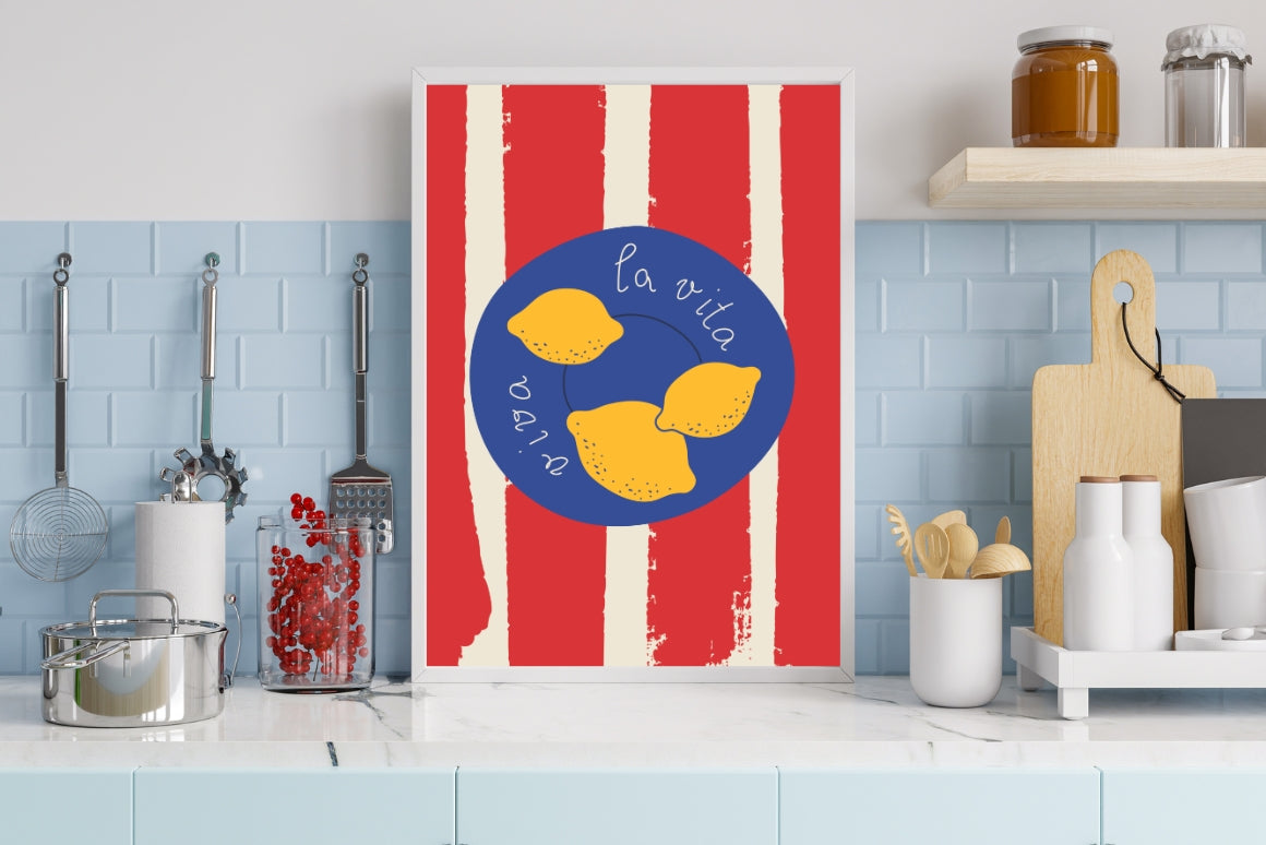 Handwritten 'Viva la vita' kitchen poster with bright yellow lemons on a blue plate and red-striped tablecloth