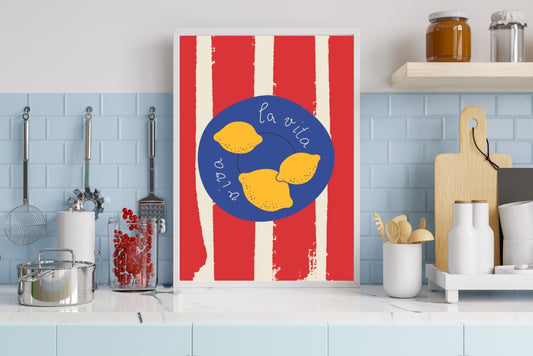Handwritten 'Viva la vita' kitchen poster with bright yellow lemons on a blue plate and red-striped tablecloth