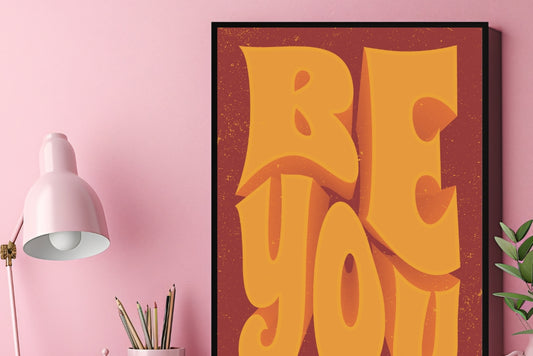 Vintage motivational quote poster with orange and yellow 3D lettering displayed in a modern office